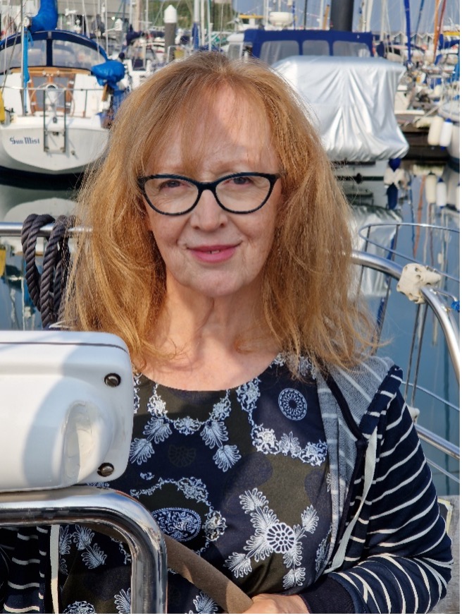 Photograph of Lesley Curwen driving a boat
