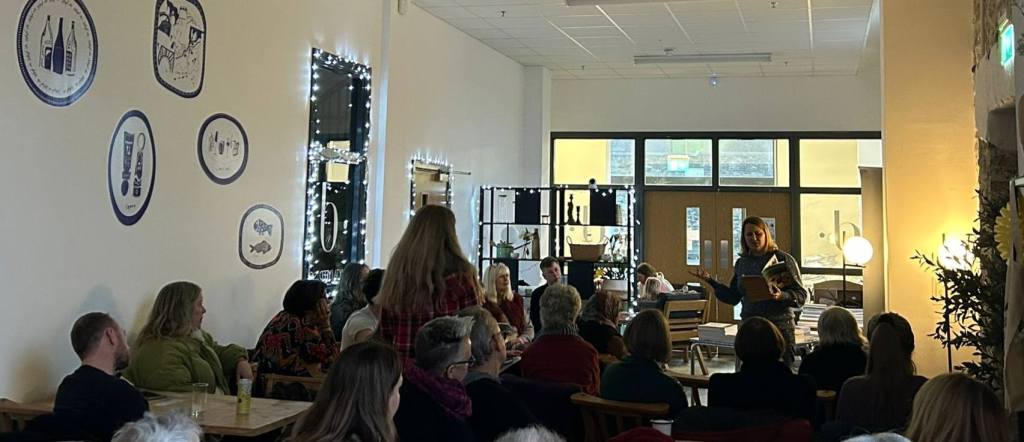 The interior of Cegin Diod with people watching the stage