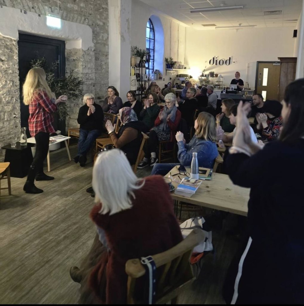 Zoe Brigley addresses a crowded room at Cegin Diod