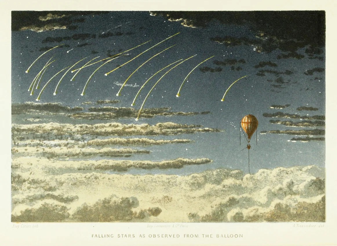 Night sky with multiple falling stars and a hot air balloon above clouds