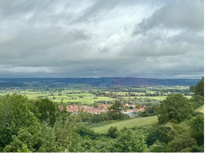 A striking view of Wells with acloudy sky and countryside stretched out